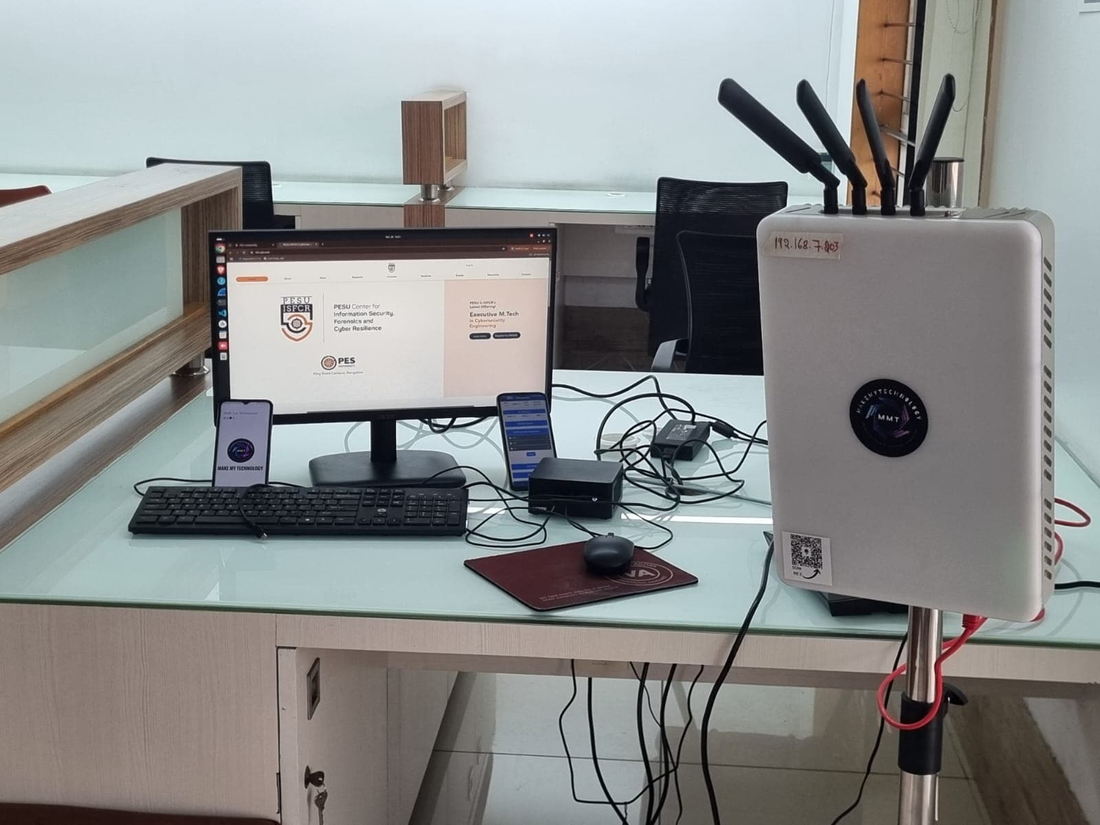 MMT 5G/6G Studio deployed at PES University — a portable MMT unit with antennas beside a monitor, running Studio Core with COTS phones.